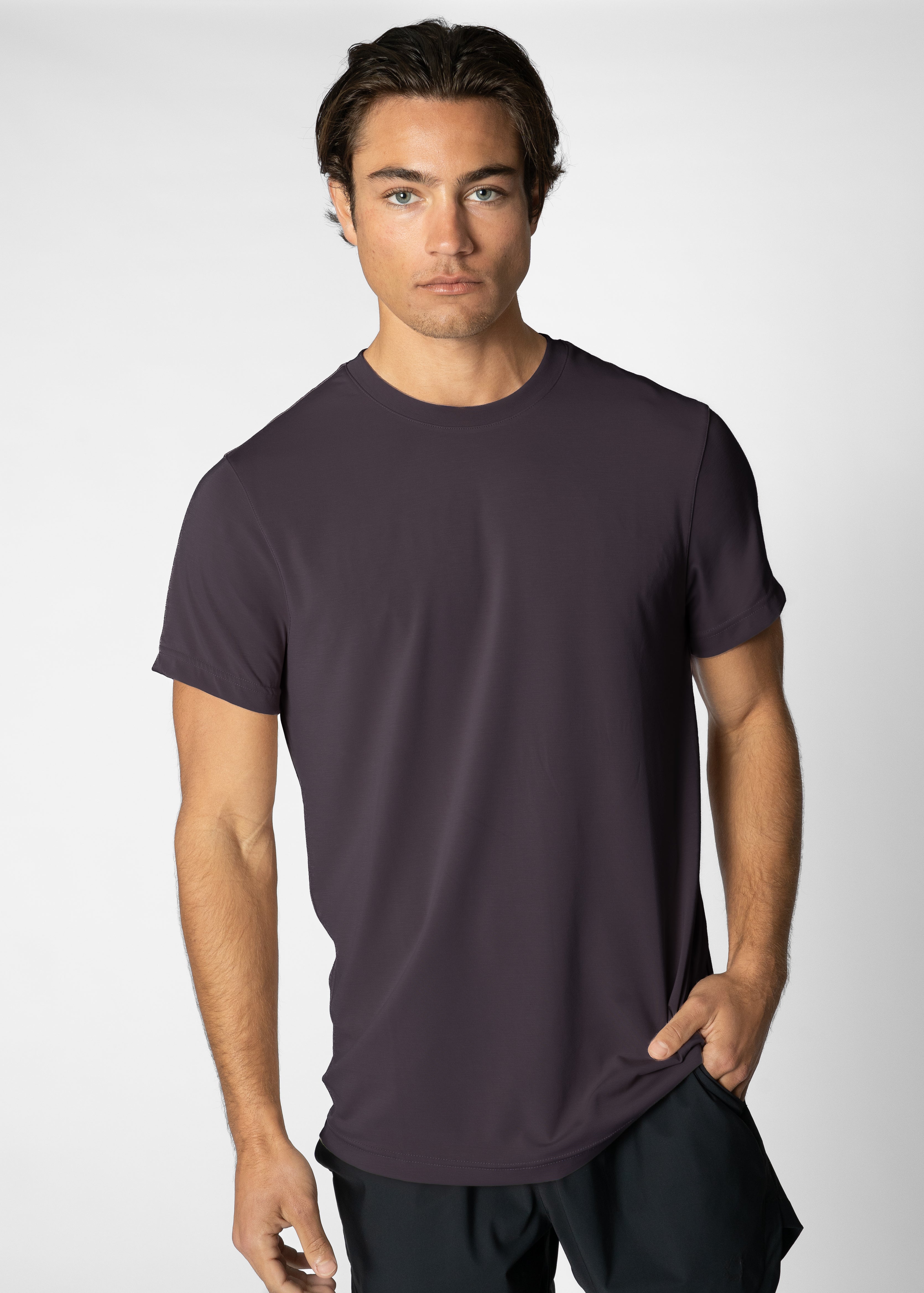 Man wearing a dark purple t-shirt against a plain background #color_dark purple #model_A
