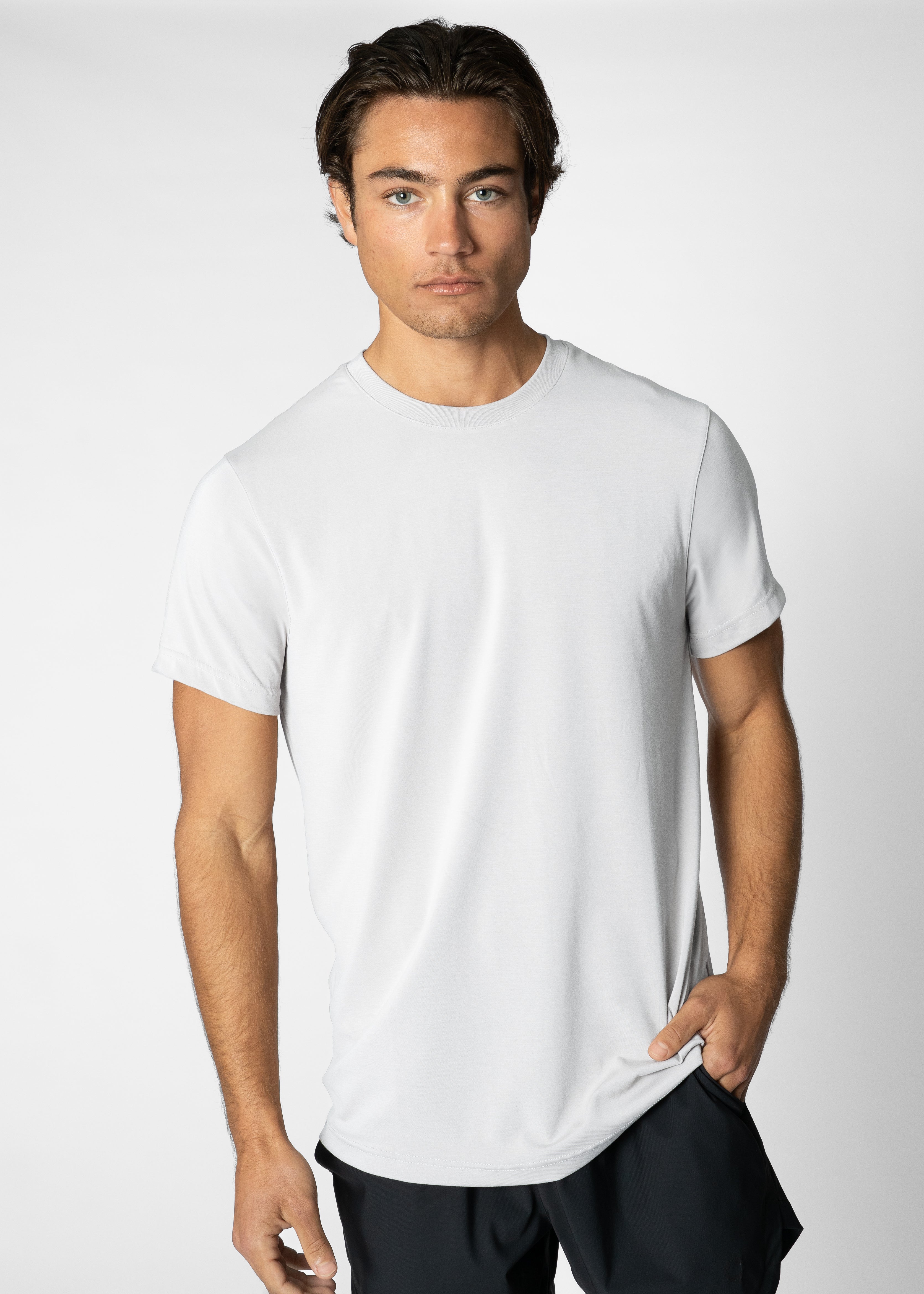 Man wearing a white t-shirt against a plain background #color_white #model_A