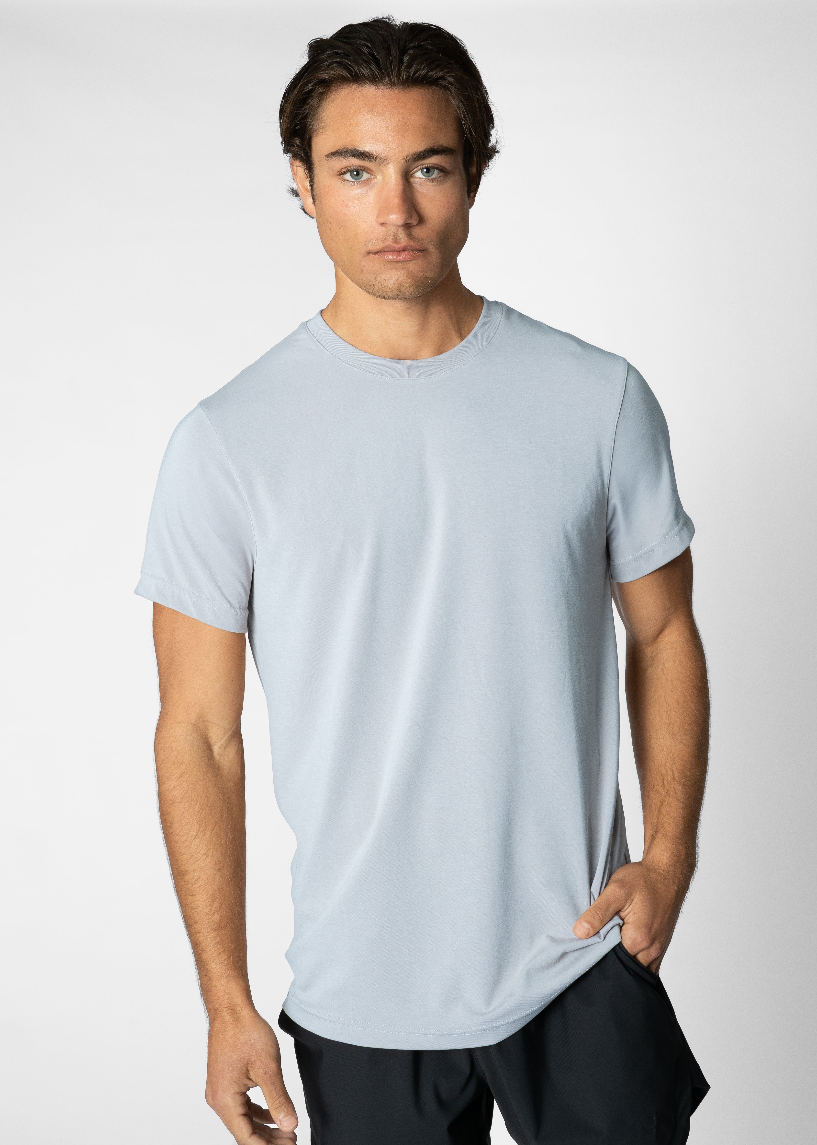 Man wearing a light blue t-shirt against a plain background #color_light blue #model_A