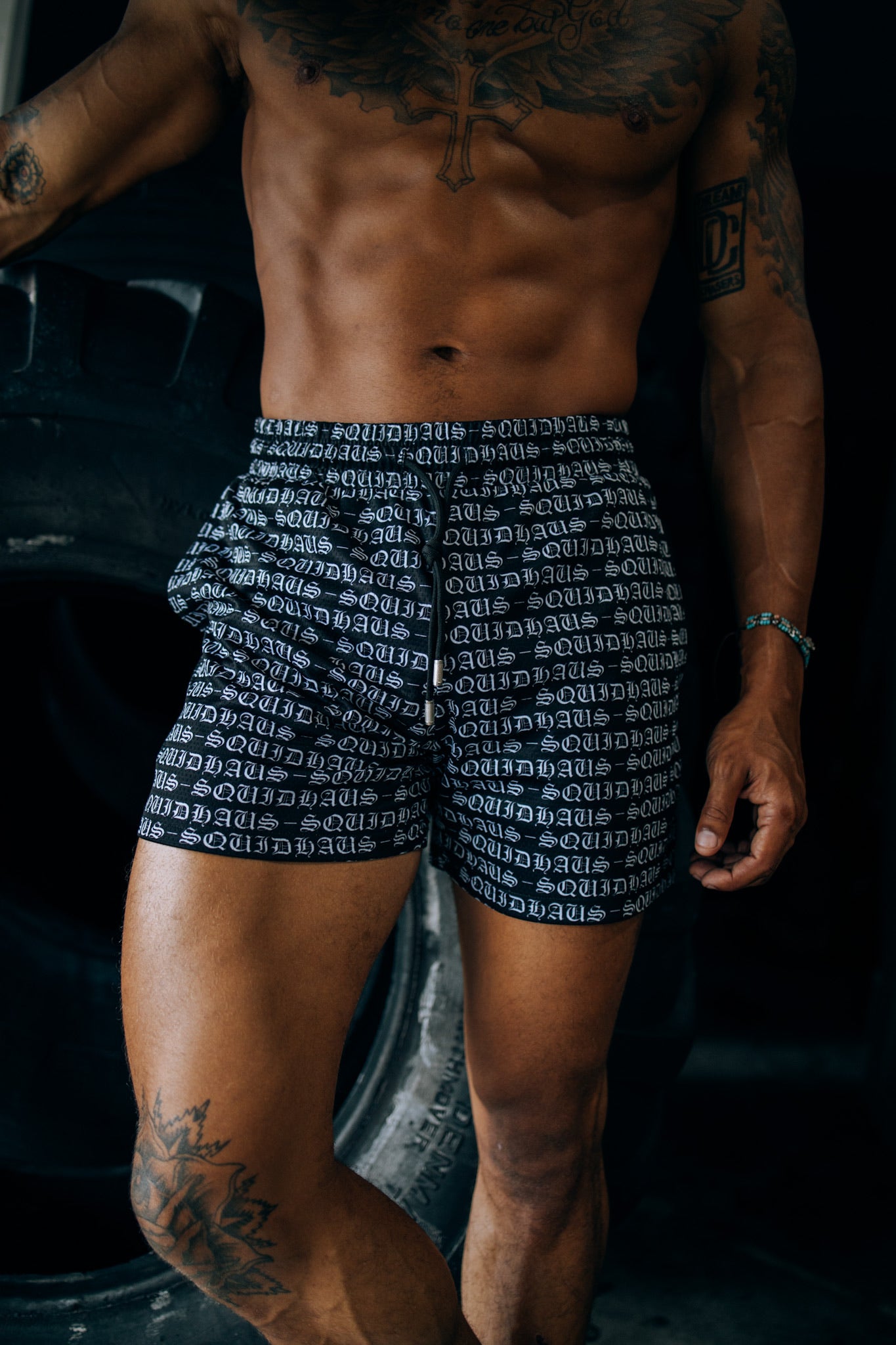 An athlete wearing 4" inseam mesh shorts in black, from SquidHaus