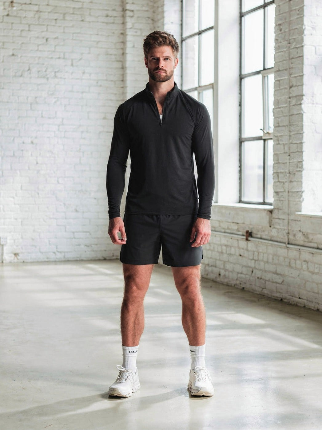 The Super Bundle worn — quarter zip and 5 inch short